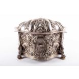 A large 19th century Peruvian attributed silver metal casket, the lobed cover repousse with rococo