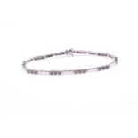 A 9ct white gold and diamond bracelet, of articulated bar link design, set with ten rows of three