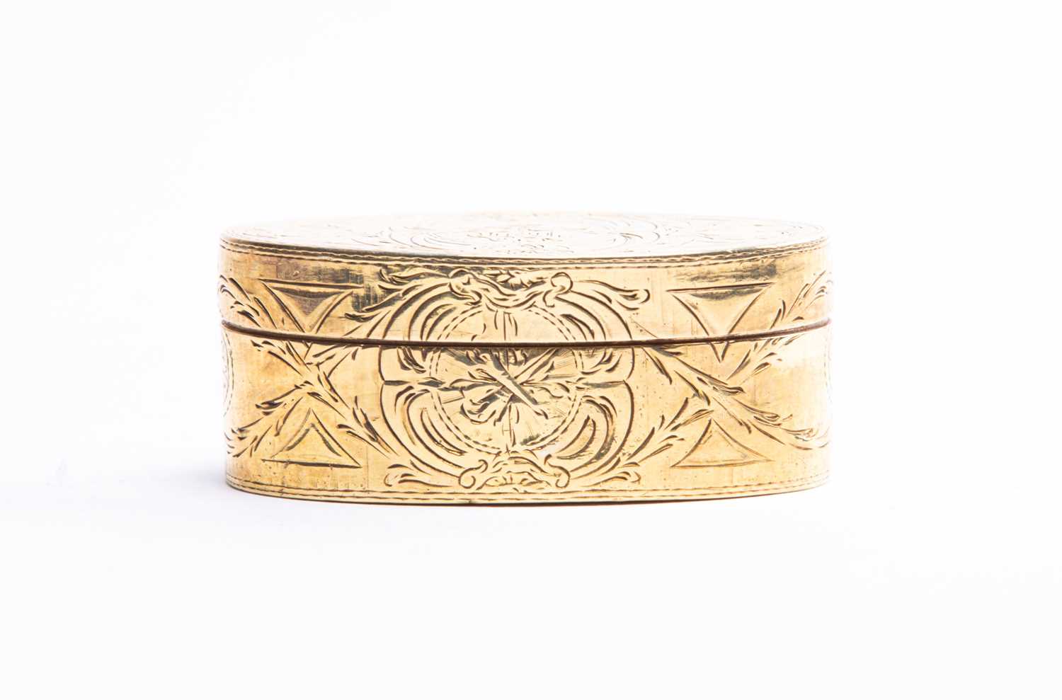 An 18th century style gilt metal snuff box of oval form, with engraved foliate decoration, 6.5 cm