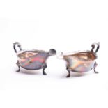 Pair of George V silver sauce boats, London 1912 by Carrington and Co, with scroll handles on