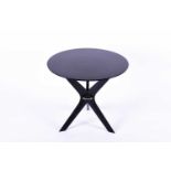 A Birgit Israel ebonised side table, the circular top with dot inlay, supported on boomerang