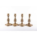 A set of four Hanau silver gilt candlesticks, of pierced cylindrical form on a shaped circular base,