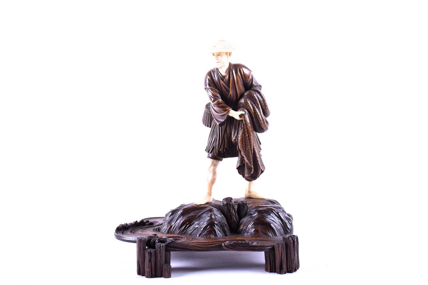 A Japanese carved wood and ivory figure of a fisherman, Meiji period, 日本，象牙木雕渔夫像一个，明治时期 the well