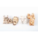 Four Japanese carved ivory netsuke, Meiji, comprising an actor holding an oni mask whilst a young