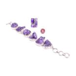 A silver and amethyst bracelet set with six naturalistic-shaped segments, each inset with a