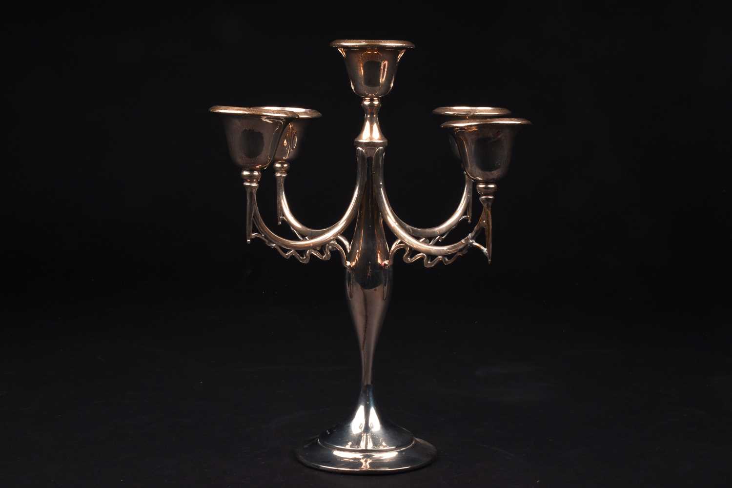 A 20th century silver candlestick, date and maker's mark rubbed, with four swept arms and central