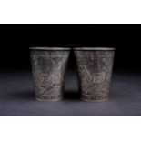 A pair of Persian silver beakers, circa 1900 Isfahan, in the style of Hajiji, one decorated with