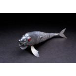 A white metal articulated fish, early 20th century, with red glass eyes, the tail struck Alpaca,