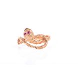 A mid to late 20th century yellow metal snake ring, set with small ruby eyes, indistinct marks to