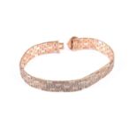 A 9ct yellow, white, and rose gold ladies watch strap, with textured articulated links, bearing