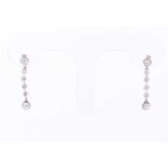 A pair of diamond pendant earrings, the six old brilliant cut diamonds vertically set in claw and