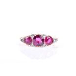 A late Victorian three stone half hoop ruby ring, the mixed circular cut rubies in pierced and