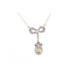 A diamond and peridot drop pendant necklace, the silver bow-shaped mount suspended with an oval