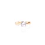 A single stone diamond ring, the round brilliant cut diamond in simple four claw mount, to plain,