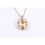 A fine 18ct yellow gold, diamond, and yellow sapphire pendant, set with a square cushion-cut natural