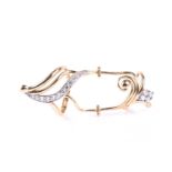 An unusual elongated hinged dress ring, the scrolling open framework set with white stones and