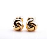 Cartier. A pair of 18ct yellow gold cufflinks, of knotted design, numbered B32552 to centre,