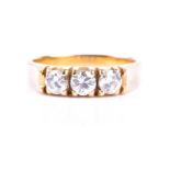 A three stone half hoop diamond ring, the round brilliant cut diamonds in raised four claw mounts to