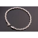 An 18ct white gold and diamond line bracelet, set with round brilliant-cut diamonds of approximately