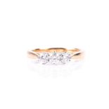 A three stone half hoop diamond ring, the round brilliant cut diamonds in simple claw mounts to an