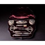 A matched Victorian silver vanity set, in fitted leather and velvet lined case, comprising two cover