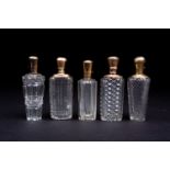 Five 19th century French 18ct gold mounted cut glass scent bottles, the cut glass of rectangular,