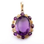 A yellow metal, amethyst glass and pearl pendant, set with a mixed oval-cut purple stone, within a