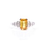 A diamond and yellow sapphire cocktail ring, set with a mixed rectangular-cut sapphire of