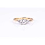 A three stone diamond half hoop ring, the central round brilliant cut diamond flanked by pear-shaped