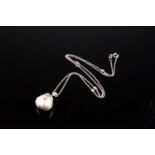 An 18ct white gold, diamond, and pearl pendant necklace, the South Sea pearl of naturalistic form,