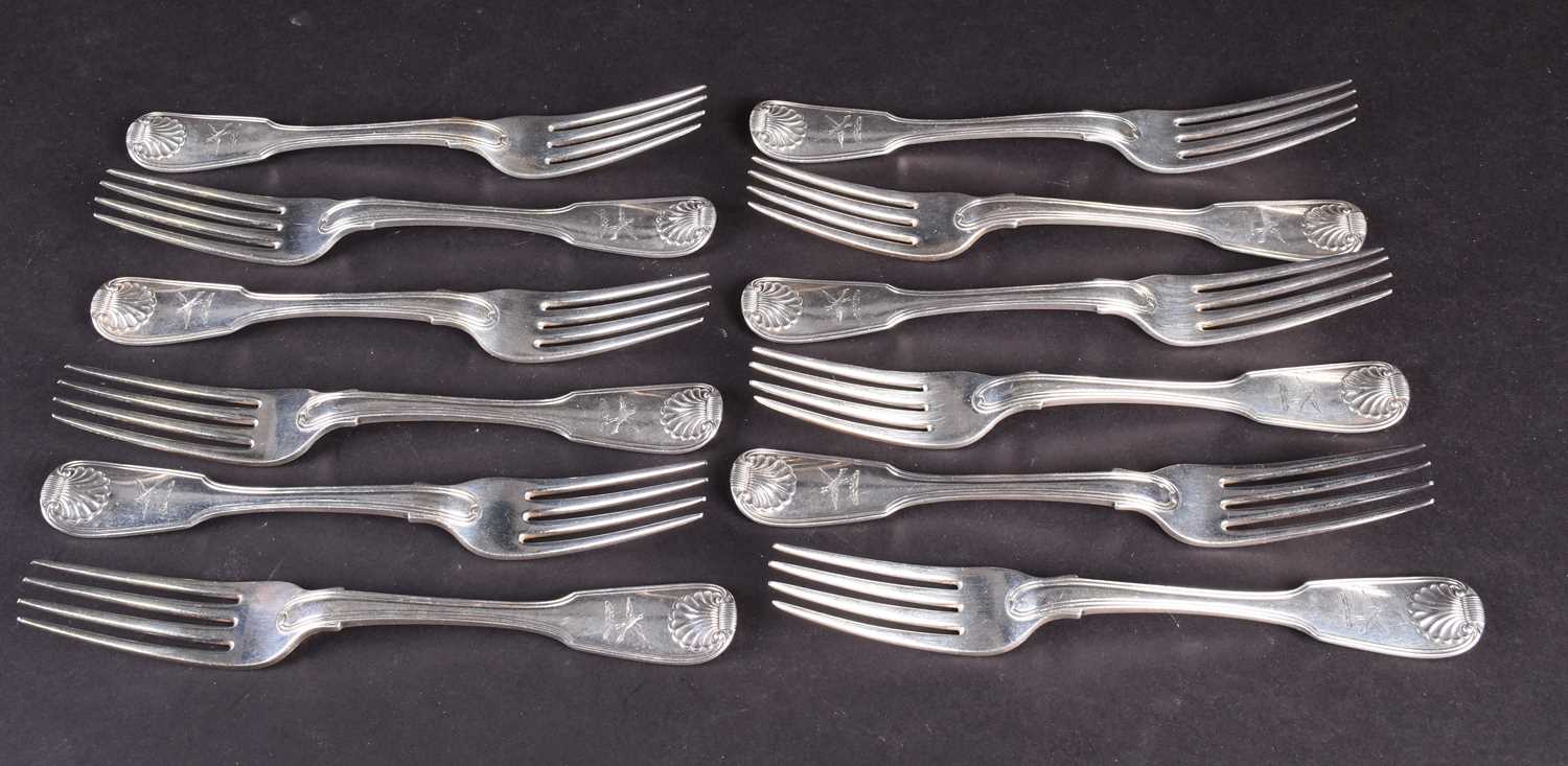 A set of twelve George III silver table forks, London 1819 by William Chawner, fiddle pattern with