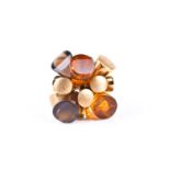 A mid to late 20th century 18ct yellow gold and amber cocktail ring, set with articulated amber