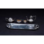 A novelty silver miniature tea set, comprised of tea pot, coffee pot, milk jug and sugar bowl,