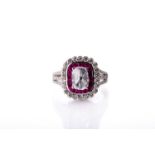 An 18ct white gold, diamond, and ruby cluster ring, set with an oval rose-cut diamond, measuring