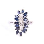 A sapphire and diamond cluster ring, the marquise shaped sapphires bordering an 's' shaped band of