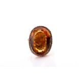 A 14ct yellow gold, diamond, and citrine cocktail ring, set with a large mixed oval-cut citrine