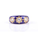 A three stone diamond and enamel half hoop gypsy set ring, the slightly graduated round brilliant