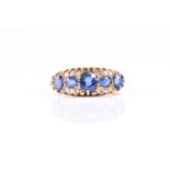 An Edwardian sapphire and diamond 18ct gold five stone half hoop ring, the five slightly graduated