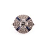 A diamond and sapphire target style circular cluster ring, in the Art Deco taste, centred with a