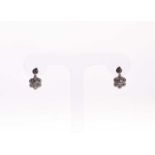 A pair of diamond daisy cluster drop earrings, the flowers inset with round brilliant-cut