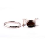 A Danish silver cuff bangle, inset with an oval tigers eye, internal diameter approximately 6 cm,