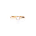 A single stone emerald cut diamond ring, in simple four claw mount to 18ct yellow gold shank,