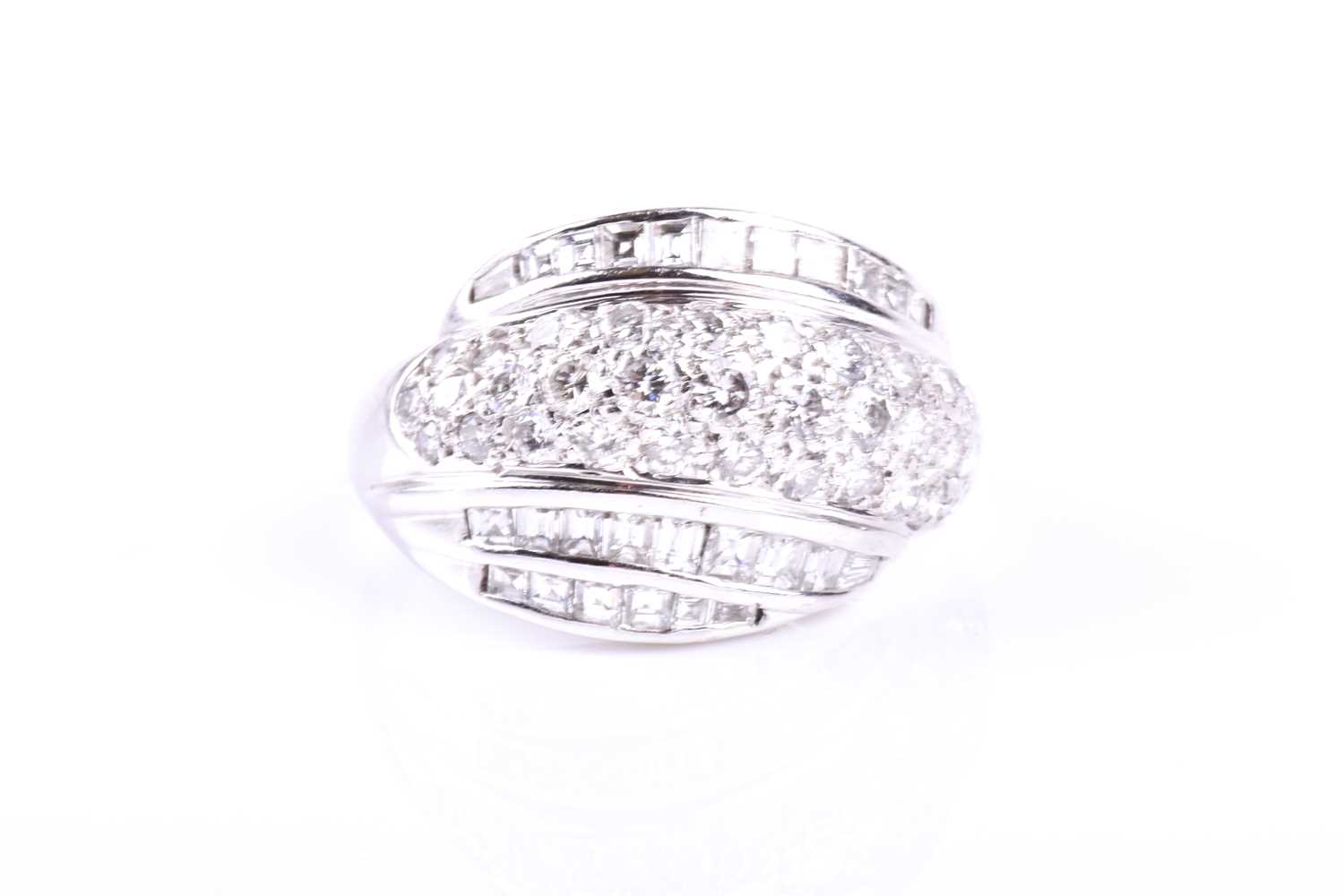 An 18ct white gold and diamond swirled bombe-style ring, pave-set with round brilliant-cut diamonds,