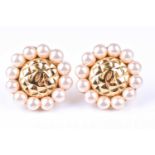 A pair of vintage Chanel earrings, with gold tone centres of quilted design, surrounded with faux