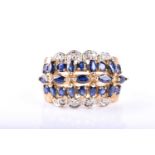 A sapphire and diamond cluster ring, the circular cut and marquise-shaped sapphires within a