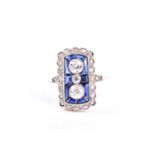 An Art Deco style sapphire and diamond ring, rounded rectangular, with three graduated diamonds to