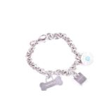 A Tiffany silver charm bracelet, hung with three Tiffany charms, 18cm length; 36.3 grams, in Tiffany