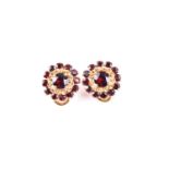 A pair of garnet cluster earrings, the openwork circular clusters set with circular cut garnets,