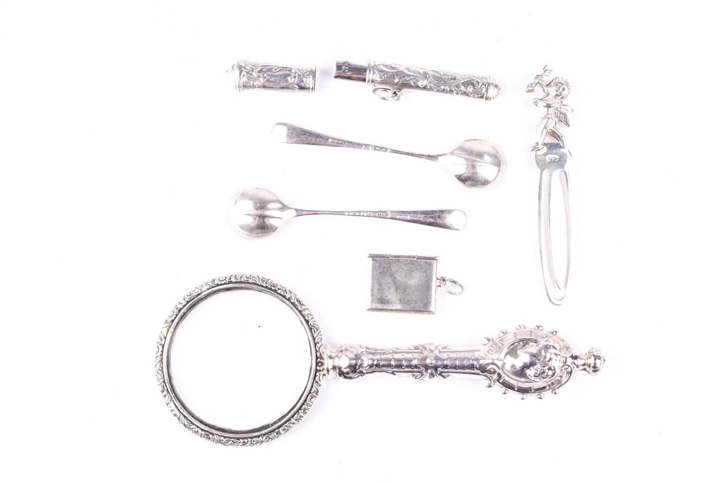 A white metal mounted magnifying glass, with cherub decoration, together with a pair of silver - Image 3 of 3