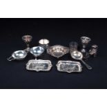 A mixed collection of silver and white metal items, to include a pair of egg cups, strainers, a pair